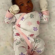 Avaia is registered to the contest to win money with this photo: baby, infant, onesie, mittens, socks, lying_down, bed, mattress, pattern, floral, cute, child, newborn, sleepwear, pink, white, purple, red, face, portrait