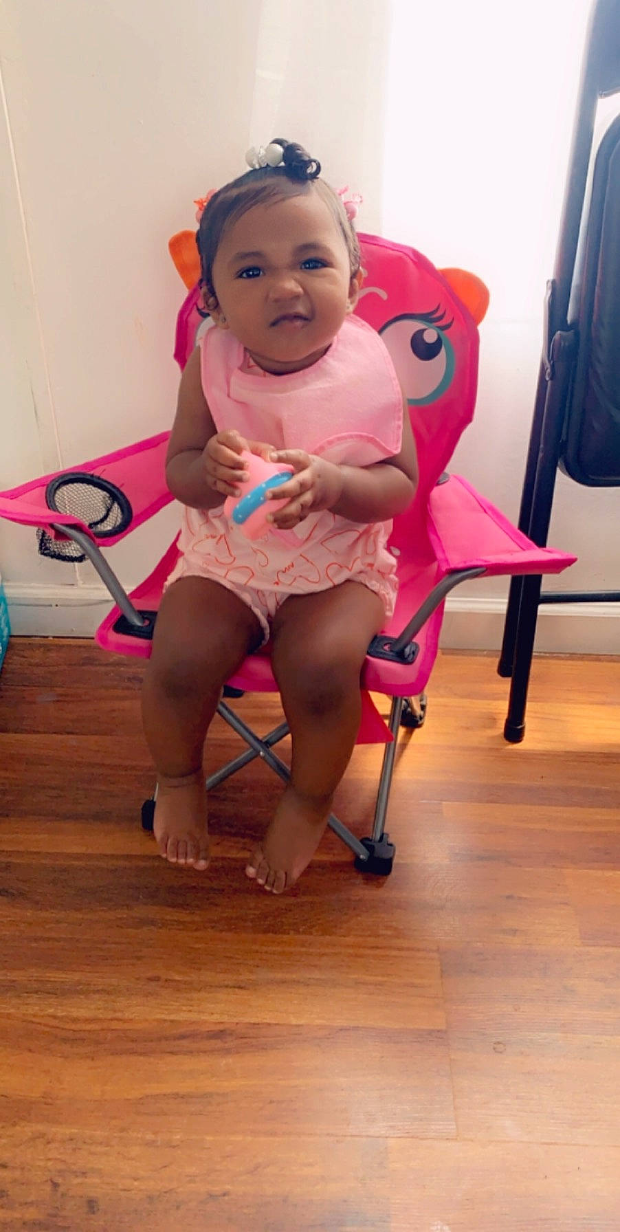 Faithlynn is registered to the contest to win money with this photo: baby, chair, child, costume, human_leg, joint, leg, person, pink, smile, thigh, toddler