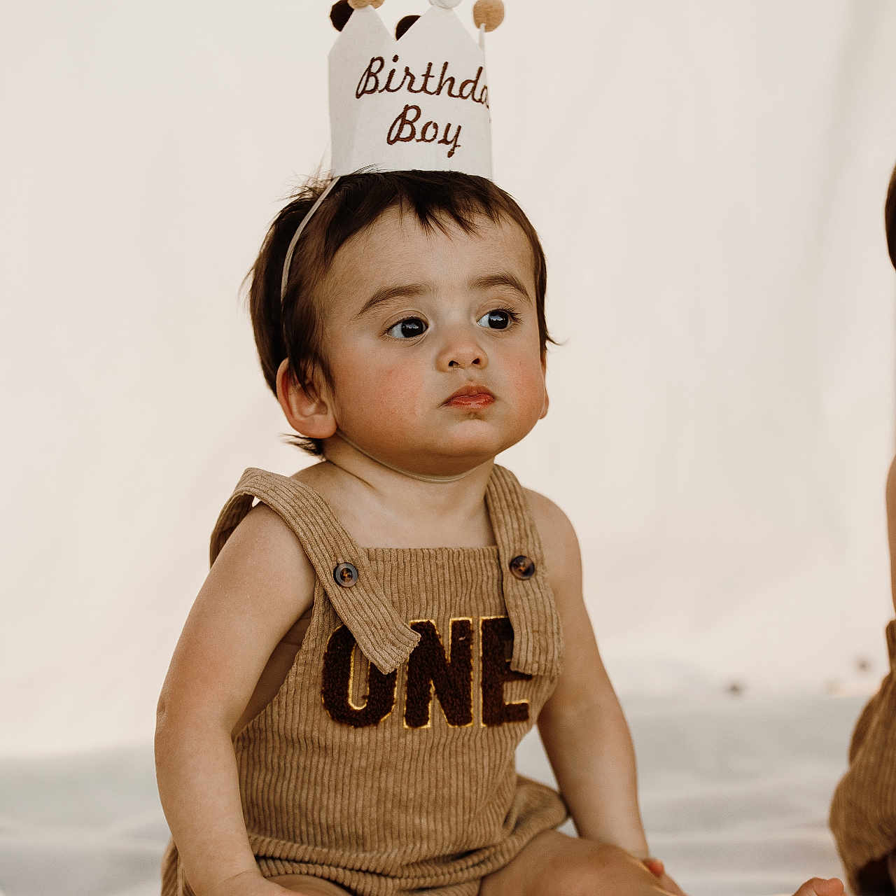 Bishop joined the competition — help win amazing prizes! baby, birthday, blanket, celebration, child, cloth, crown, cute, event, expressionless, face, headwear, indoor, infant, one_year_old, portrait, romper, sitting, soft_texture, young_child