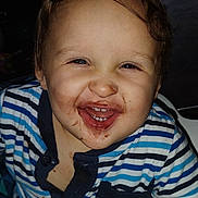 Sylas joined the competition — help win amazing prizes! toddler, child, smiling, face, chocolate, messy, high_chair, striped_shirt, happy, indoors, baby, cute, young_child, food, mess, hand, portrait, person, clothing, seat