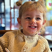 Lyna a rejoint le concours — aidez-le/la à gagner de superbes lots ! bokeh, bowl, buttons, child, daisy_patch, earrings, eating, girl, hair, indoor, knitwear, pigtails, portrait, restaurant, smile, spoon, sweater, table, teeth, toddler