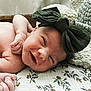 baby, newborn, infant, smile, headband, bow, blanket, pattern, floral, knitted, cozy, skin, hand, face, sleepy, cute, lying, resting, indoors, portrait