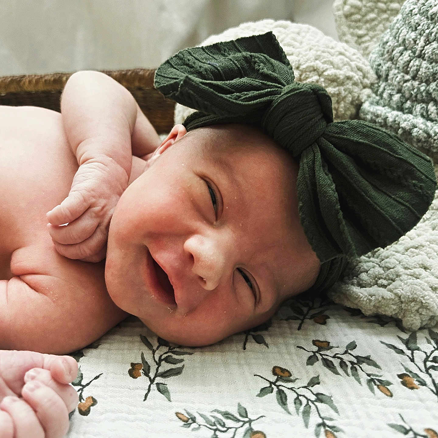 Scarlett joined the competition — help win amazing prizes! baby, blanket, bow, cozy, cute, face, floral, hand, headband, indoors, infant, knitted, lying, newborn, pattern, portrait, resting, skin, sleepy, smile