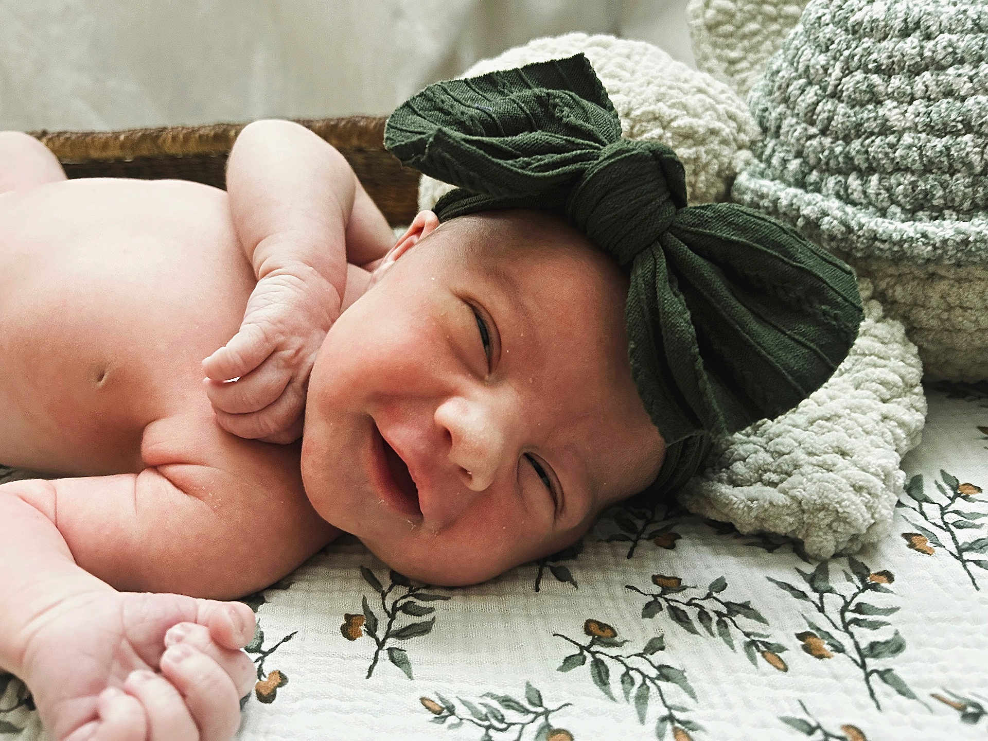 Scarlett joined the competition — help win amazing prizes! baby, newborn, infant, smile, headband, bow, blanket, pattern, floral, knitted, cozy, skin, hand, face, sleepy, cute, lying, resting, indoors, portrait