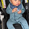 Drayden is registered to the contest to win money with this photo: baby, child, infant, car_seat, pacifier, blue_clothing, hooded_outfit, sitting, cute, indoor, person, young_child, socks, face, headwear, seatbelt, warning_label, black_car_seat, expression, hands