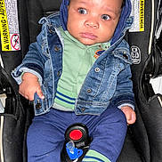 Drayden joined the competition — help win amazing prizes! baby, child, denim_jacket, blue_pants, striped_socks, car_seat, pacifier, infant, cute, wide_eyes, clothing, seatbelt, indoor, holding, jacket, expression, portrait, person, sitting, young