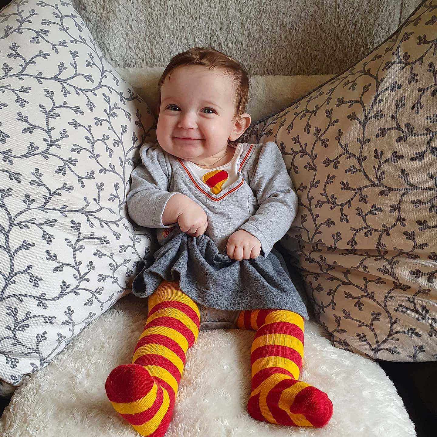 Elodie joined the competition — help win amazing prizes! baby, baby_toddler_clothing, chair, comfort, dress, eye, face, happy, head, human_body, joy, lap, leg, outerwear, person, photograph, sleeve, smile, sock, textile