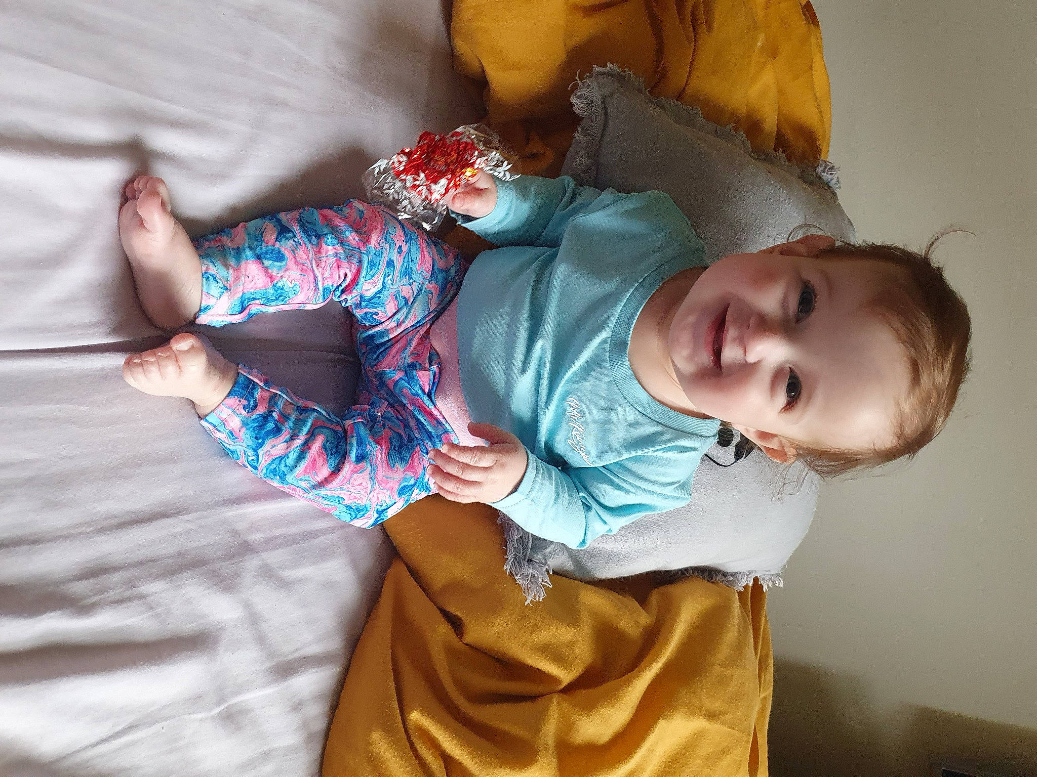 Elodie is registered to the contest to win money with this photo: arm, baby, baby_toddler_clothing, cheek, comfort, eye, face, finger, gesture, hand, head, human_body, iris, joint, joy, organ, person, skin, sleeve, smile