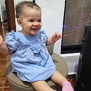 Madison a rejoint le concours — aidez-le/la à gagner de superbes lots ! toddler, child, smiling, blue_dress, pink_socks, indoor, stool, happy, cute, person, face, hair, earrings, window, reflection, floor, furniture, skin, sitting, joyful