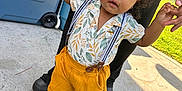 Jaxon is registered to the contest to win money with this photo: adult_hands, baby, barefoot, child, concrete, cooler, curly_hair, daylight, greenery, outdoor, person, playtime, shirt, shorts, snack_box, summer, support, suspenders, toddler, walking