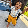 adult_hands, baby, barefoot, child, concrete, cooler, curly_hair, daylight, greenery, outdoor, person, playtime, shirt, shorts, snack_box, summer, support, suspenders, toddler, walking