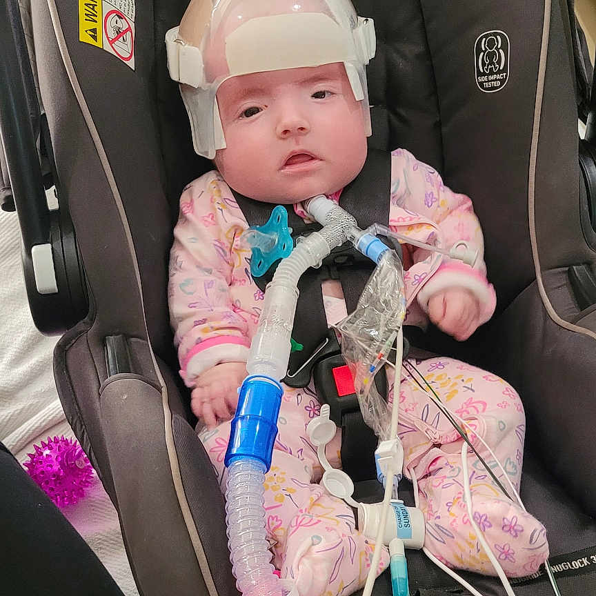 Raylan is registered to the contest to win money with this photo: baby, cap, clothing, coat, crib, cushion, electronics, face, furniture, glove, hat, head, helmet, infantbed, jacket, person, photography, portrait, transportation, vehicle