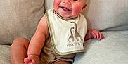 Sylas joined the competition — help win amazing prizes! baby, smiling, bib, giraffe, couch, infant, child, happy, sitting, clothing, cheeks, face, foot, hand, indoors, cute, portrait, skin, person, comfortable