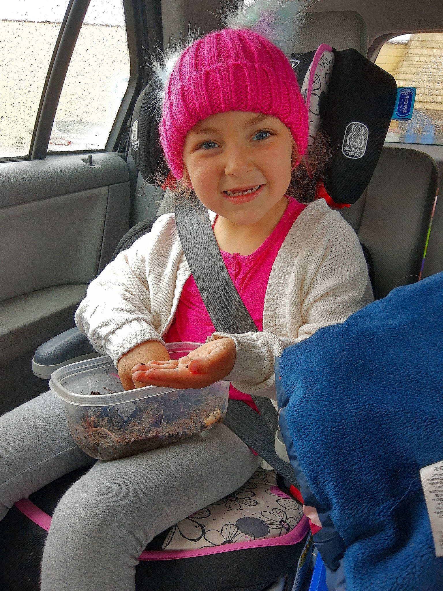 Scarlett joined the competition — help win amazing prizes! auto_part, baby_in_car_seat, car, car_seat, car_seat_cover, child, family_car, headgear, headwear, joy, knit_cap, knitting, passenger, person, pink, seat_belt, steering_wheel, toddler, vacation, vehicle