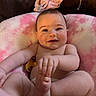 Miley is registered to the contest to win money with this photo: baby, infant, smile, face, skin, hand, foot, pacifier, cushion, pink, white, child, cute, indoors, happy, chubby, person, lying, expression, soft
