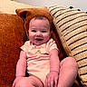 baby, child, smiling, sitting, couch, pillow, indoors, happy, infant, person, cute, clothing, skin, face, legs, hand, home, relaxing, portrait, cozy