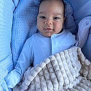 David joined the competition — help win amazing prizes! baby, blanket, blue, beige, clothing, face, infant, portrait, cozy, soft, cute, comfort, expression, lying_down, child, person, indoors, warm, small, looking