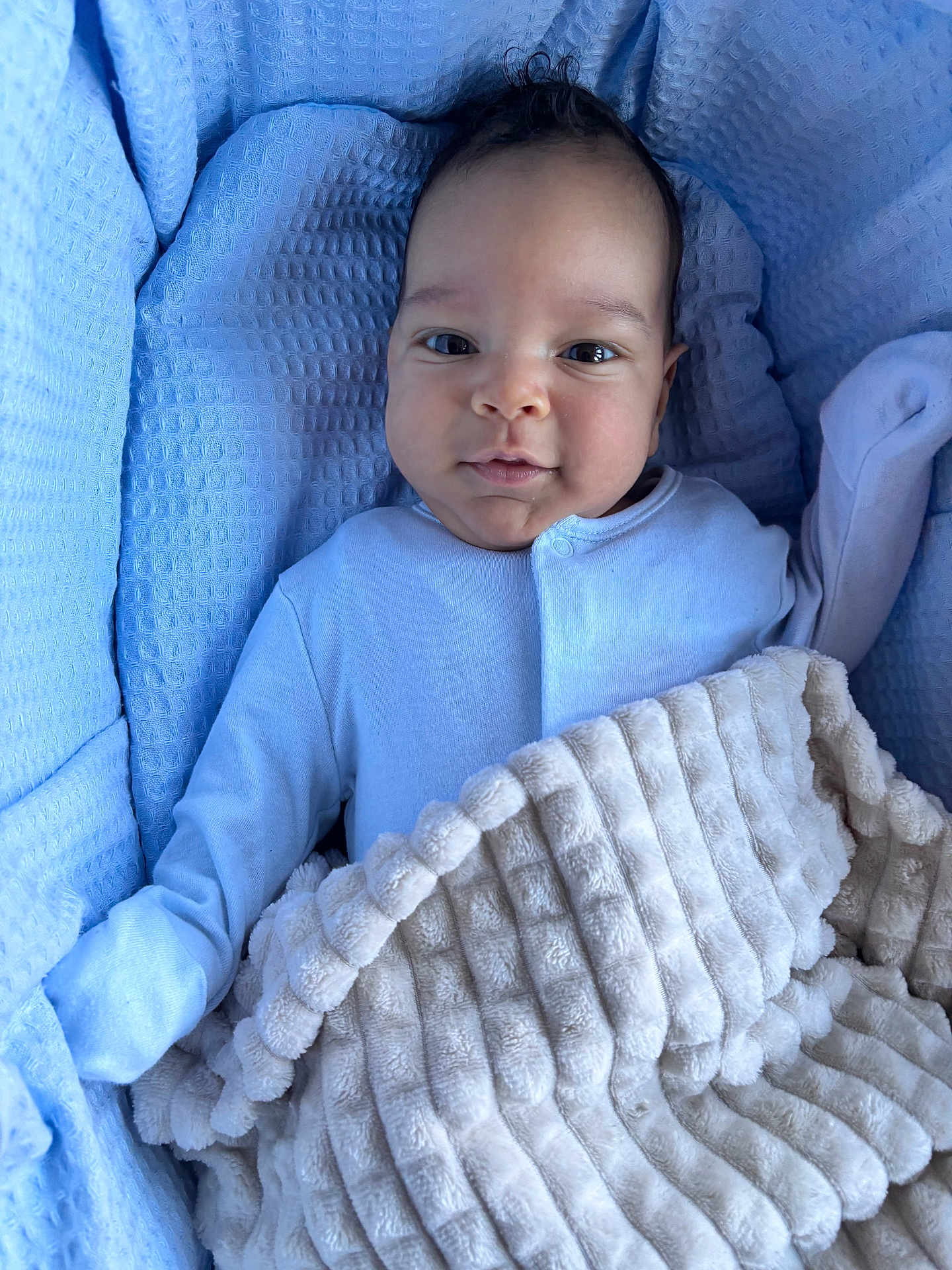 David joined the competition — help win amazing prizes! baby, blanket, blue, beige, clothing, face, infant, portrait, cozy, soft, cute, comfort, expression, lying_down, child, person, indoors, warm, small, looking