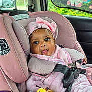 Ariyana joined the competition — help win amazing prizes! baby, car_headrest, car_interior, car_seat, car_window, child, child_safety, colorful, curious_expression, cute, headwear, infant, pink_clothing, plush_toy, safety_harness, seatbelt, smiling, toy, unicorn, window_shade