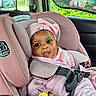 baby, car_headrest, car_interior, car_seat, car_window, child, child_safety, colorful, curious_expression, cute, headwear, infant, pink_clothing, plush_toy, safety_harness, seatbelt, smiling, toy, unicorn, window_shade