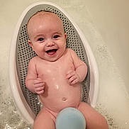 Roman is registered to the contest to win money with this photo: baby, bath, bathtub, bubbles, child, smiling, happy, water, skin, infant, seat, foam, person, cute, playful, clean, tub, bath_time, sponge, naked