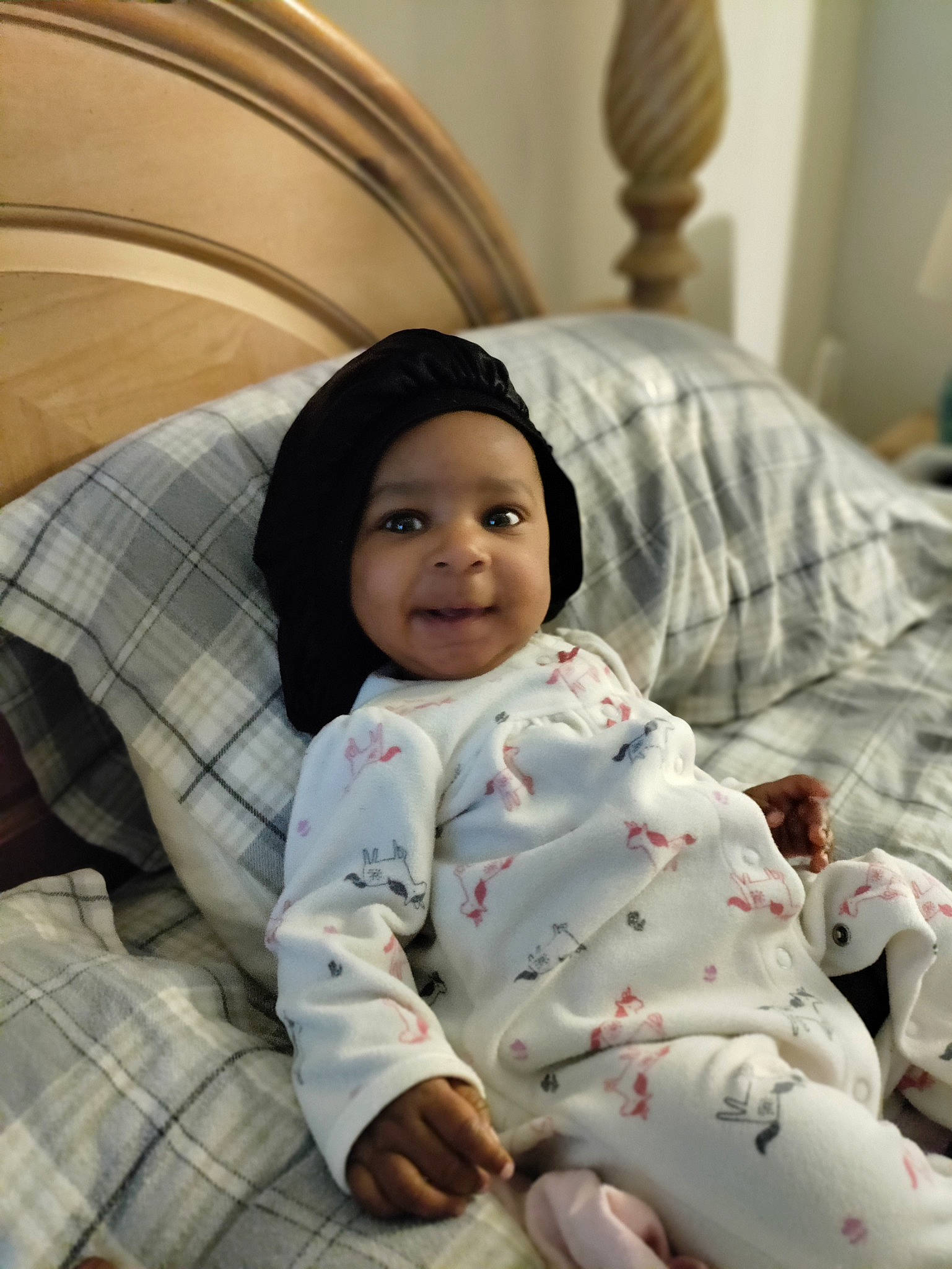 Sha'Nay joined the competition — help win amazing prizes! baby, baby_toddler_clothing, bed_sheet, bedding, cheek, child, comfort, fun, happy, headwear, joy, linens, pattern, person, plaid, room, sitting, skin, sleeve, smile