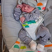 Robyn joined the competition — help win amazing prizes! baby, baby_rocker, child, clothing, colorful, cozy, cute, fabric, headband, indoor, infant, newborn, onesie, patterned, peaceful, person, resting, sleeping, small, soft
