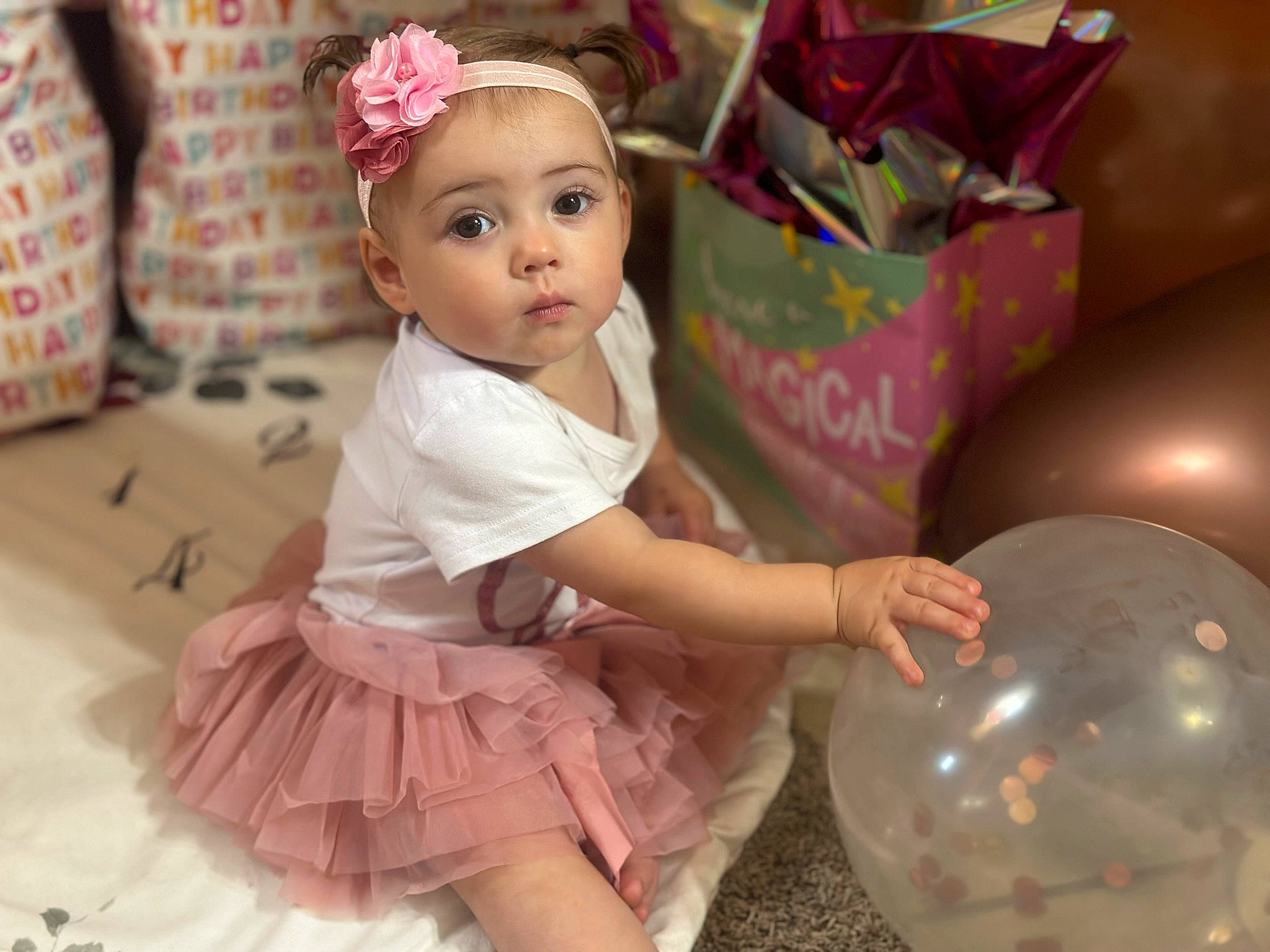 Lilly is registered to the contest to win money with this photo: baby, baby_toddler_clothing, balloon, child, dress, embellishment, event, fashion_accessory, fun, happy, headband, headpiece, magenta, party, party_supply, person, pink, recreation, sitting, toddler