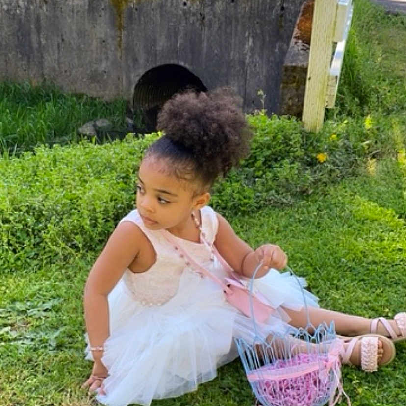 Sonora joined the competition — help win amazing prizes! backyard, basket, child, clothing, dress, face, female, girl, grass, head, lawn, nature, outdoors, person, photography, plant, portrait, purple, sitting, yard