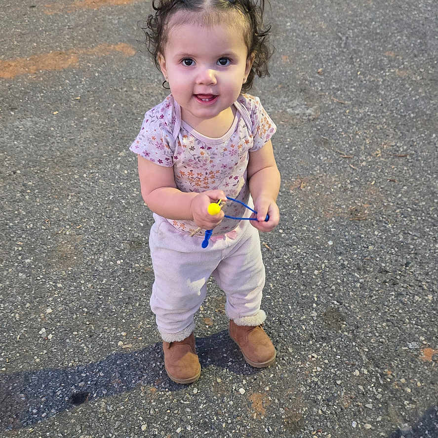 Ariana is registered to the contest to win money with this photo: car, child, city, clothing, face, female, girl, head, jeans, pants, person, photography, portrait, road, street, tarmac, transportation, urban, vehicle, walking