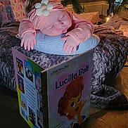 Raya joined the competition — help win amazing prizes! baby, blanket, book, child, christmas_tree, cozy, decorations, floor, flower, headband, holiday, indoors, lucille_ball, pillow, portrait, presents, relaxing, sleeping, soft_lighting, toddler