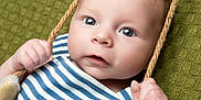 Leighton joined the competition — help win amazing prizes! baby, infant, child, face, eyes, hands, rope, swing, striped_clothing, blue_and_white, texture, green_background, portrait, closeup, cute, curious, soft_lighting, skin, young, indoor