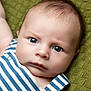 Leighton is registered to the contest to win money with this photo: baby, infant, face, closeup, blue_eyes, striped_clothing, arm_raised, expression, curious, texture, green_blanket, portrait, skin, head, person, newborn, cute, young_child, soft_light, indoor