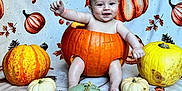 Leighton is registered to the contest to win money with this photo: baby, pumpkin, costume, autumn, fall, orange, yellow, green, white, smiling, cute, child, seasonal, holiday, festive, background, blanket, sitting, decor, portrait
