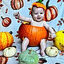 baby, pumpkin, costume, autumn, fall, orange, yellow, green, white, smiling, cute, child, seasonal, holiday, festive, background, blanket, sitting, decor, portrait