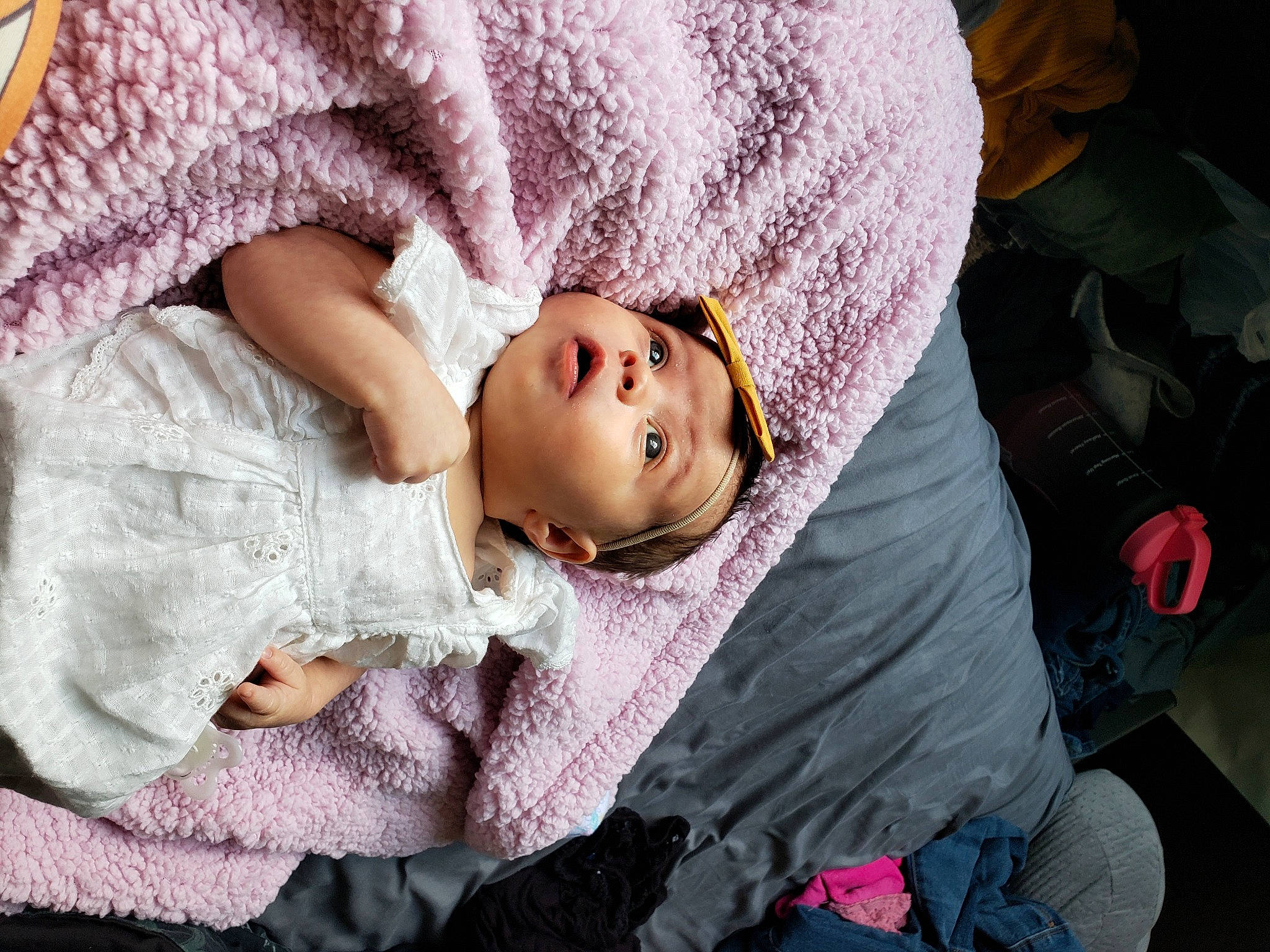 Benelli is registered to the contest to win money with this photo: baby, child, comfort, eye, eyelash, fur, happy, head, headgear, human_body, linens, magenta, nap, pattern, person, pink, purple, sitting, skin, sleeve