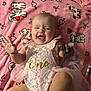 Renesmee joined the competition — help win amazing prizes! baby, infant, pink_blanket, lace_outfit, one_year, smiling, happy, toy, cute, toddler, hand_raised, foot, blanket_pattern, dog_pattern, heart_pattern, indoor, portrait, child, celebration, soft_texture