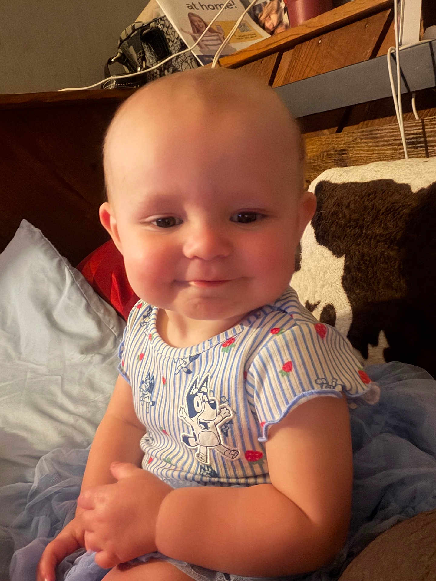 Renesmee joined the competition — help win amazing prizes! baby, child, smile, shirt, striped_clothing, cartoon_character, sitting, couch, pillow, home_interior, wooden_furniture, cute, happy, infant, plush, toddler, face, hand, blue_skirt, cozy