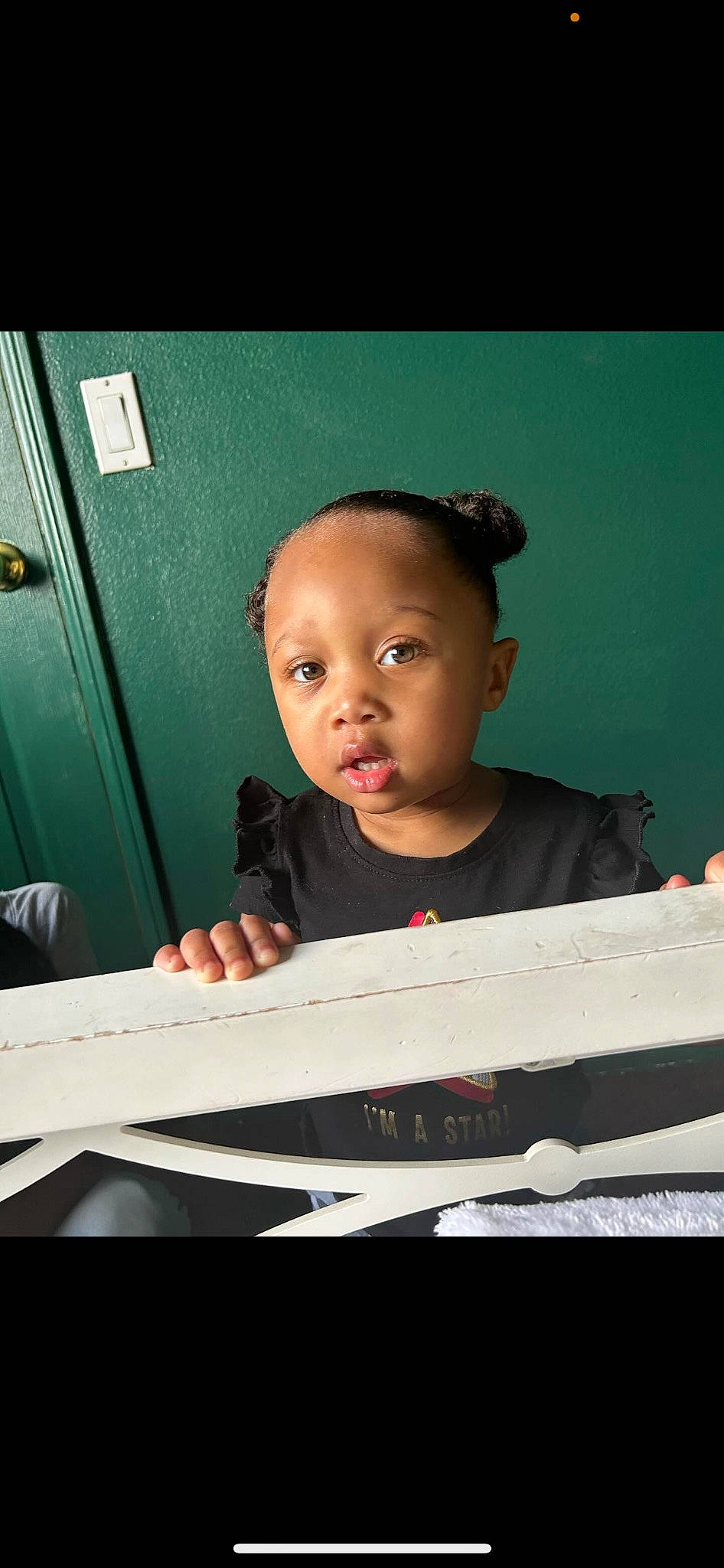 Athena is registered to the contest to win money with this photo: child, darkness, eyebrow, eyewear, flash_photography, fun, hairstyle, happy, jewellery, person, portrait_photography, room, sitting, t_shirt, tints_and_shades, toddler