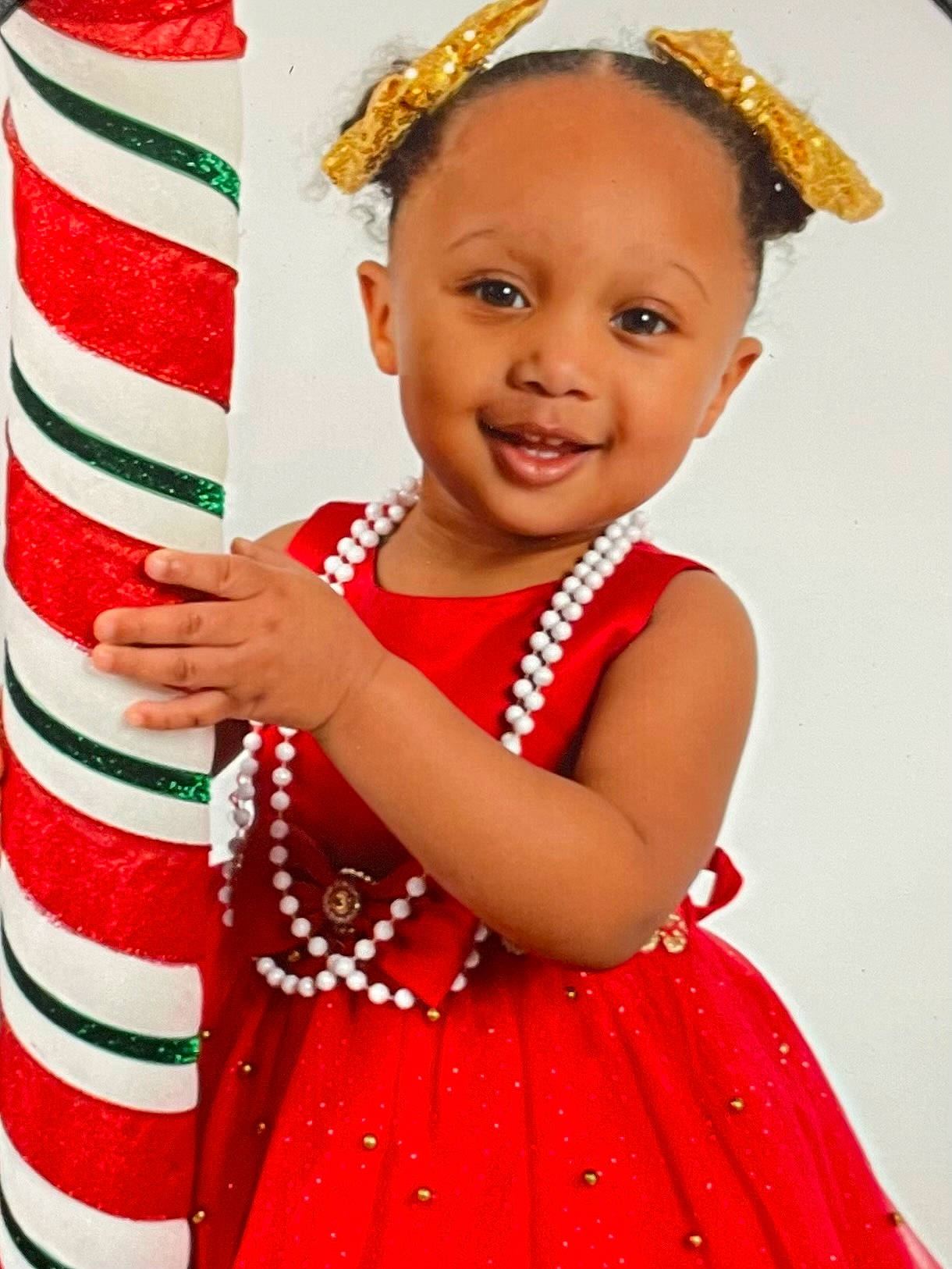 Athena is registered to the contest to win money with this photo: baby_toddler_clothing, child, costume_hat, event, eye, face, fun, gesture, happy, head, human_body, joy, person, photograph, pink, red, skin, sleeve, smile, toddler