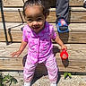 casual, child, concrete, cute, daylight, grass, hair_bun, happy, outdoor, person, pink_pajamas, playful, shadow, shoes, sippy_cup, slippers, smiling, sunlight, toddler, wooden_steps