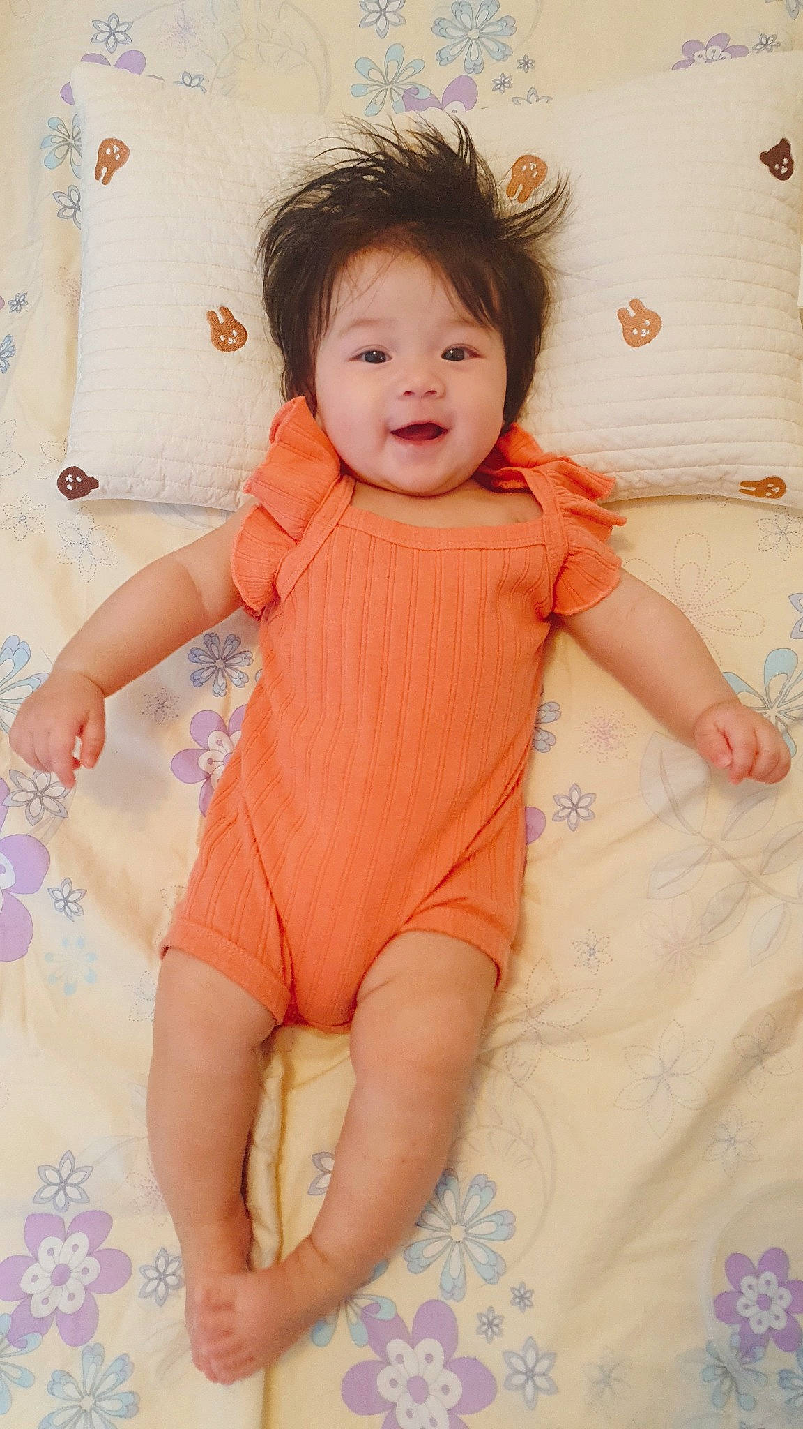 Clover is registered to the contest to win money with this photo: arm, baby_toddler_clothing, cheek, eye, face, finger, gesture, hand, happy, head, human_body, iris, joint, leg, neck, person, product, skin, sleeve, standing