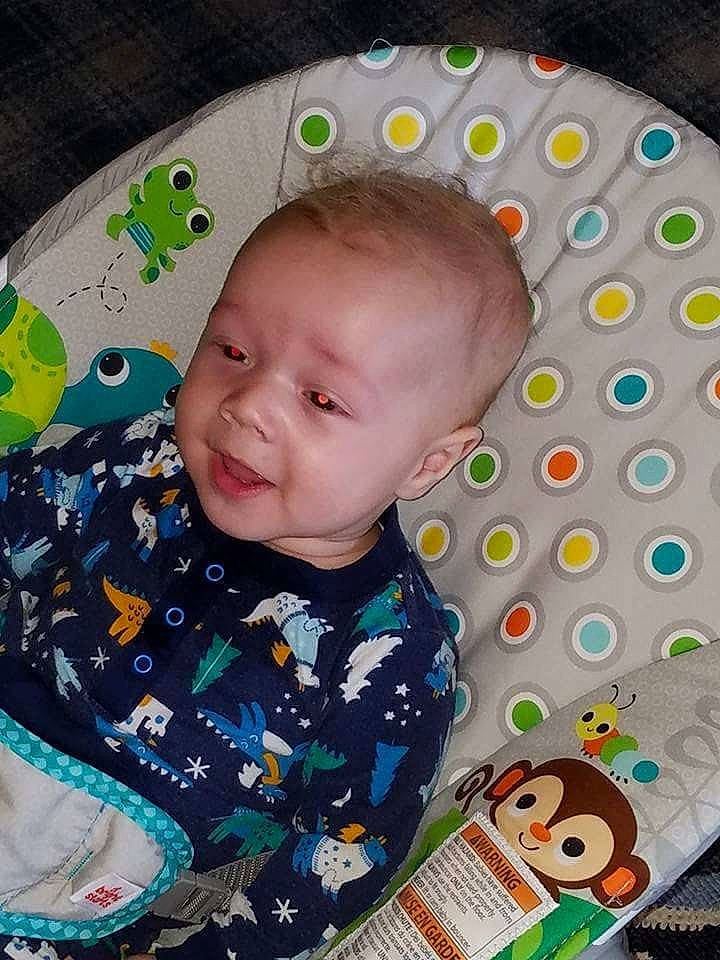 Braxton is registered to the contest to win money with this photo: baby_products, cheek, child, day, eye, facial_expression, fun, green, infant, iris, material, nose, pattern, person, play, product, skin, smile, textile, toddler