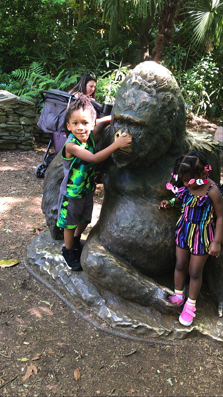 Jamil is registered to the contest to win money with this photo: adaptation, art, footwear, grass, happy, hat, joy, leisure, outdoor_recreation, people, person, plant, recreation, sculpture, shoe, shorts, sneakers, t_shirt, temple, toddler