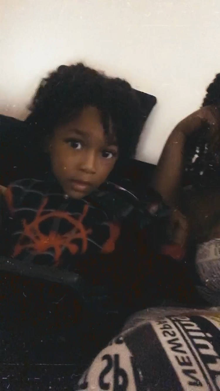 Jamil is registered to the contest to win money with this photo: audio_equipment, automotive_tire, black, black_hair, carmine, child, cool, darkness, design, doll, eye, flash_photography, fun, lip, mouth, pattern, person, ringlet, tints_and_shades, toddler