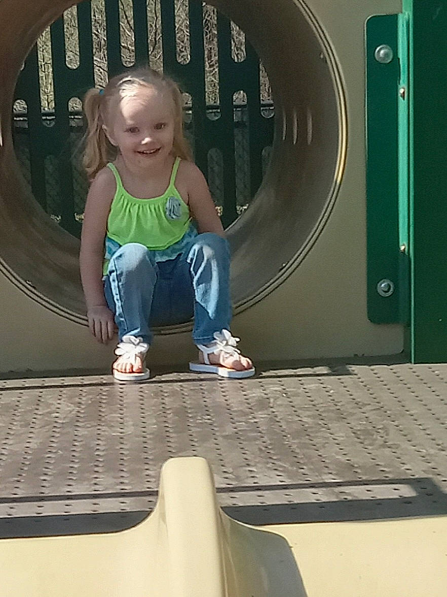 Chevy is registered to the contest to win money with this photo: automotive_tire, baby_toddler_clothing, child, circle, city, comfort, electric_blue, flooring, fun, joy, leisure, machine, person, play, recreation, sitting, symmetry, toddler