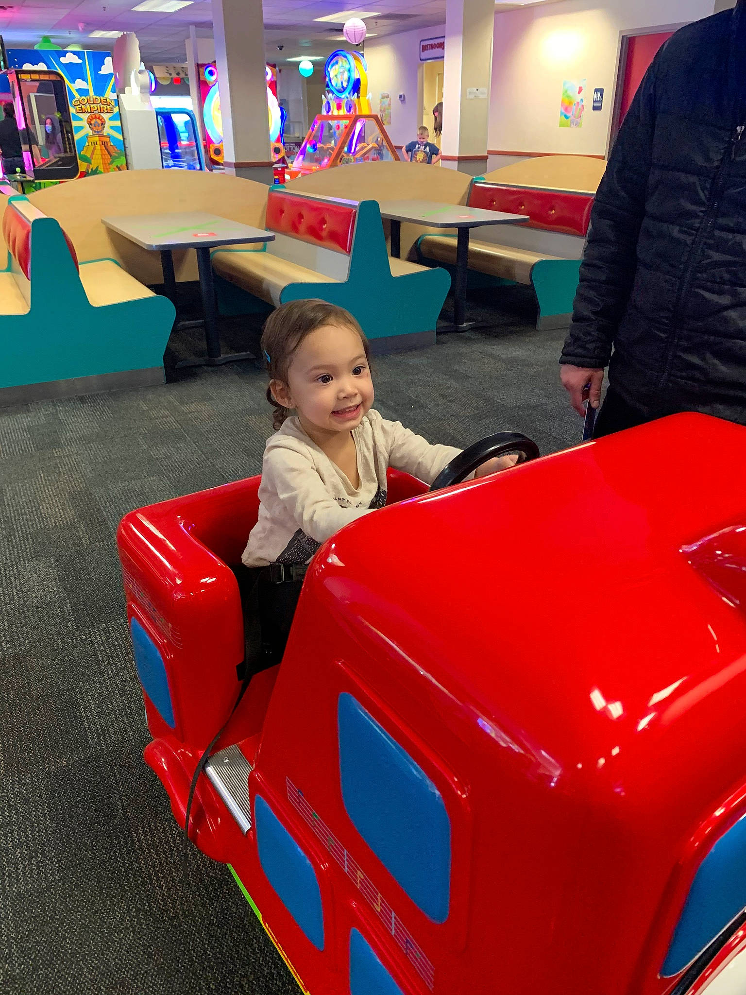 Gracelynne is registered to the contest to win money with this photo: auto_part, automotive_design, automotive_exterior, automotive_tire, bumper, chair, child, fender, flooring, fun, joy, leisure, motor_vehicle, person, product, recreation, recreation_room, riding_toy, table, tire