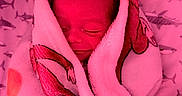 Javian is registered to the contest to win money with this photo: baby, bedding, blanket, closed_eyes, cozy, cuddled, face, hair, indoors, infant, newborn, nursery, peaceful, pink, portrait, resting, shark_pattern, sleeping, soft_blanket, swaddled