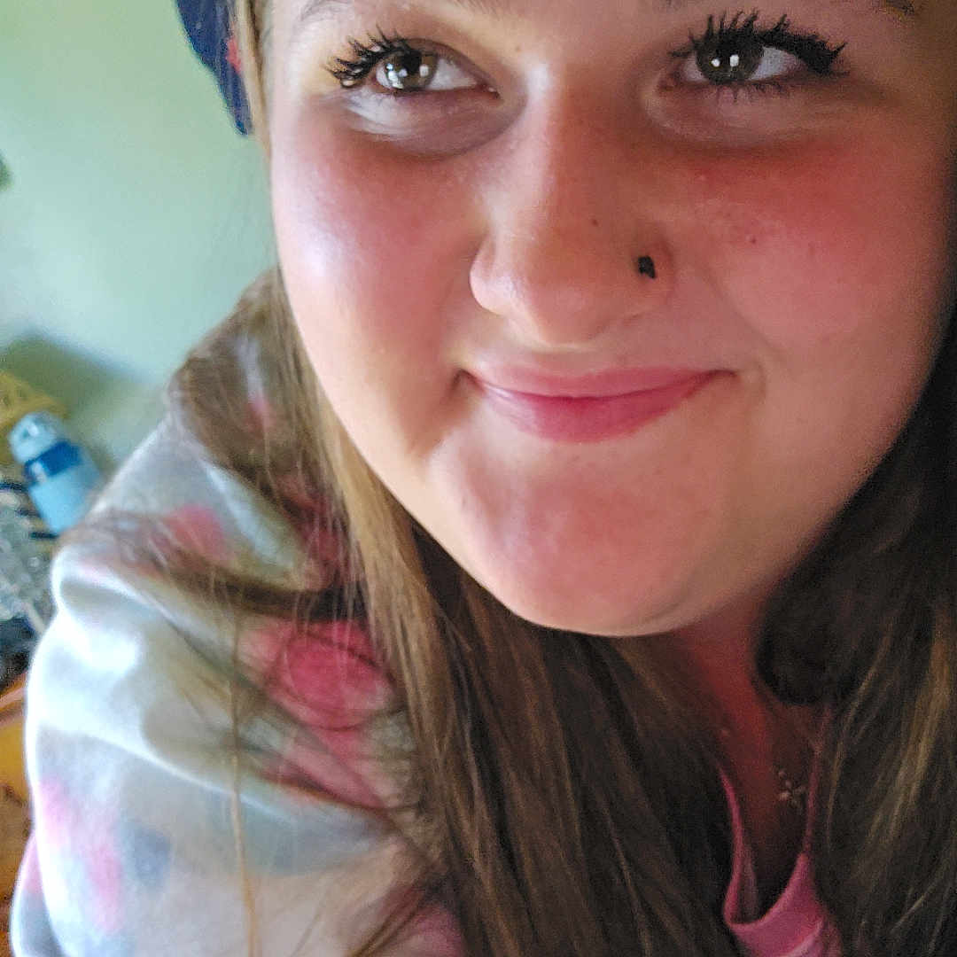 Saharah is registered to the contest to win money with this photo: background, casual, close_up, clothing, expression, eyelashes, face, hair, happy, head, indoor, light, long_hair, person, portrait, skin, smile, sweatshirt, woman, young_adult