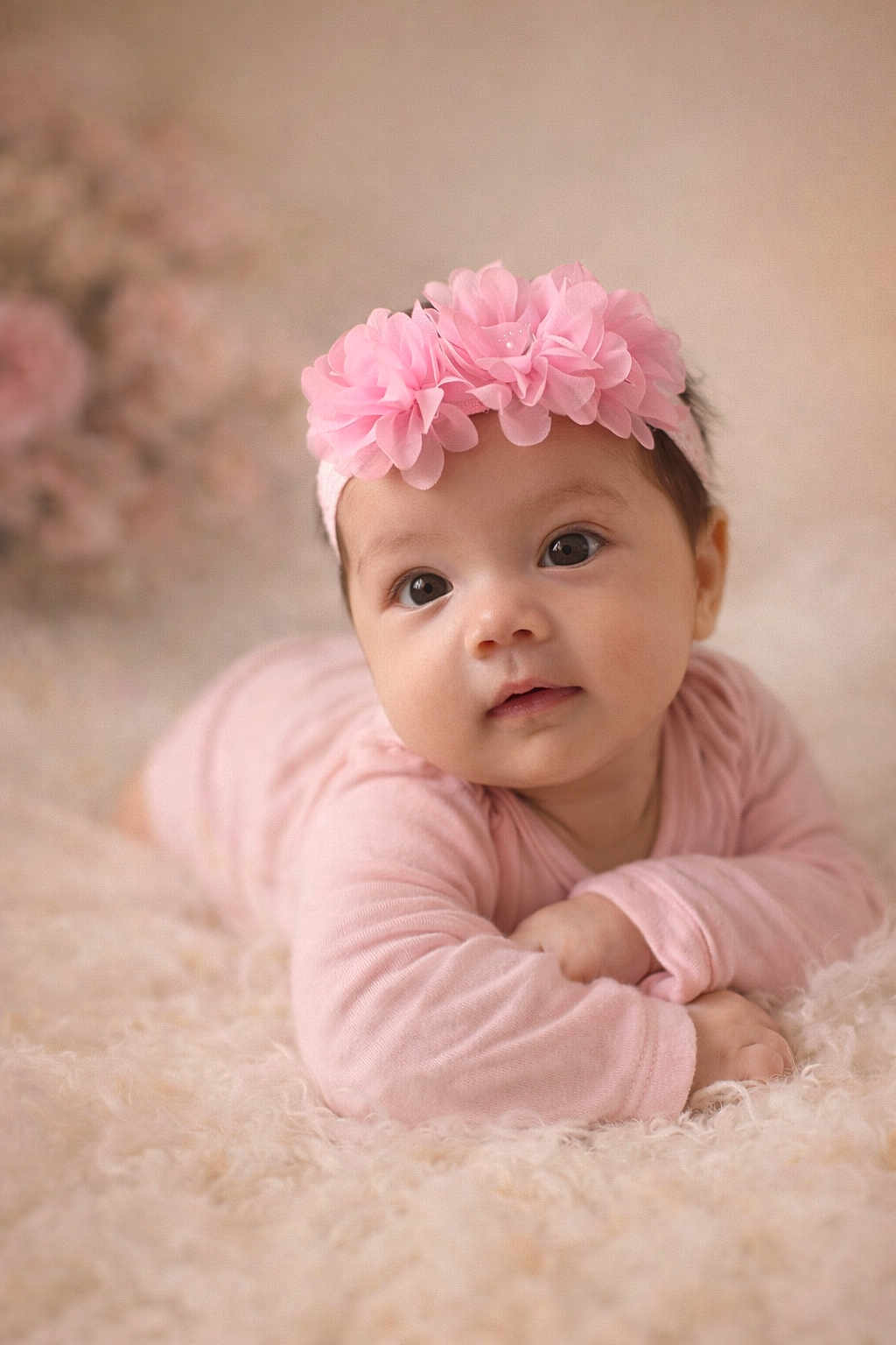 Amillia is registered to the contest to win money with this photo: baby, infant, pink_clothing, headband, flower_headband, cute, lying_down, soft_texture, blanket, closeup, portrait, child, adorable, indoor, soft_lighting, curious_expression, baby_girl, warm_colors, sleepwear, fluffy